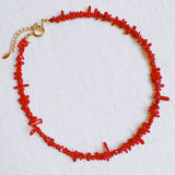 Elegant necklace featuring natural stone beads in coral-inspired shapes, available in two variants—deep red and soft white—each evoking the beauty of coastal reefs with a touch of organic charm.