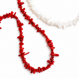 Elegant necklace featuring natural stone beads in coral-inspired shapes, available in two variants—deep red and soft white—each evoking the beauty of coastal reefs with a touch of organic charm.