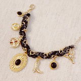 Scarf-wrapped bracelet featuring gold and sliver-tone Western-themed charms including a cowboy boot, sunburst, and lasso motifs