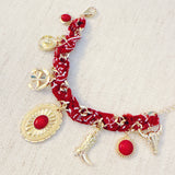 Scarf-wrapped bracelet featuring gold and sliver-tone Western-themed charms including a cowboy boot, sunburst, and lasso motifs