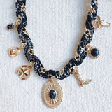 Chain necklace woven with printed scarf fabric, adorned with Western-themed charms including a boot, sunburst, and sheriff star.