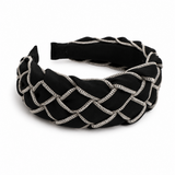 Black headband with braided design on a white background