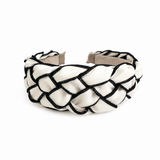 Black and white braided headband on a white background