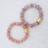 Faceted glass stretch bracelet available in soft blue or peach – pastel shine and stackable charm