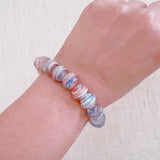 Faceted glass stretch bracelet available in soft blue or peach – pastel shine and stackable charm