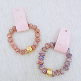 Faceted glass stretch bracelet available in soft blue or peach – pastel shine and stackable charm
