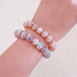 Faceted glass stretch bracelet available in soft blue or peach – pastel shine and stackable charm