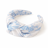 White headband with blue floral pattern on a white background