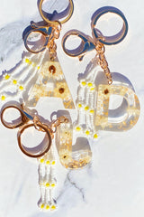 Porte-clés initial bébé marguerite