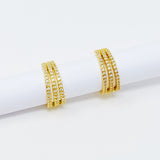 Boucles d'oreilles Huggie triple brillance