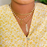 Necklace with 'MAMA' pendant on a yellow floral shirt