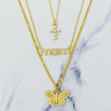 Gold butterfly necklace on a marble surface
