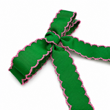 Green ribbon with pink edge on a white background