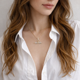 A gold chain necklace featuring a sparkling pavé T-bar pendant. The design combines a classic toggle motif with shimmering details for a sophisticated and modern finish.