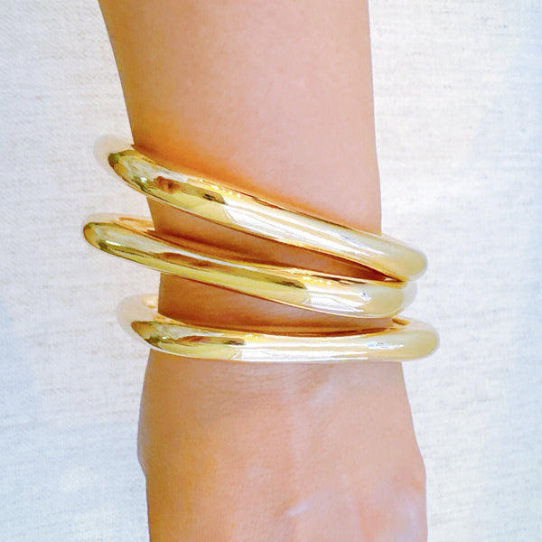 Two sets of square-shaped stacking bangles—one in solid gold-tone and one in a mixed gold and silver finish
