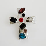 Elegant cross-shaped brooch pin with an artisan-inspired design, featuring sculpted edges and a smooth metallic finish available in gold or silver tones, perfect for adding a refined accent to jackets, scarves, or bags.