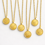 Gold necklaces with zodiac pendants on a white background