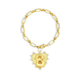 Gold bracelet with a heart-shaped charm featuring the letter 'B' on a white background