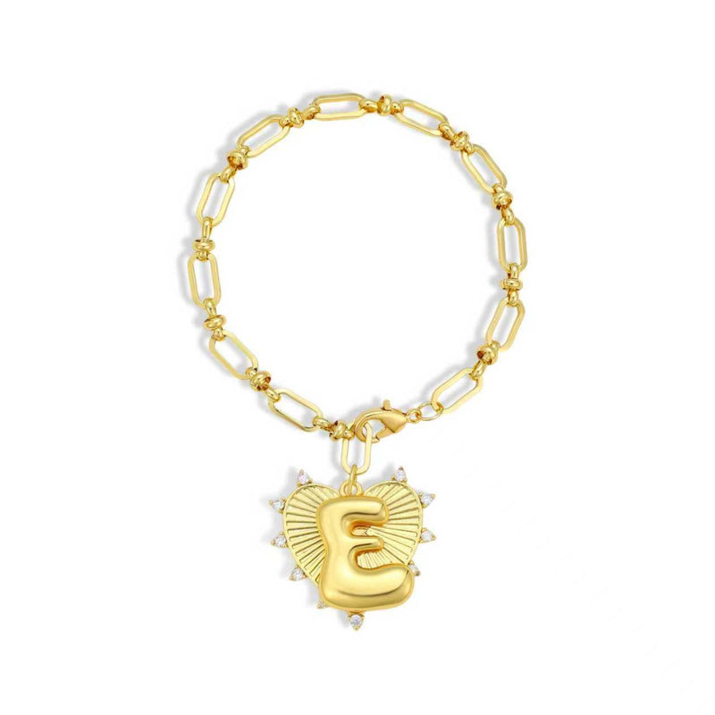 Gold bracelet with a heart-shaped charm featuring the letter 'E' on a white background