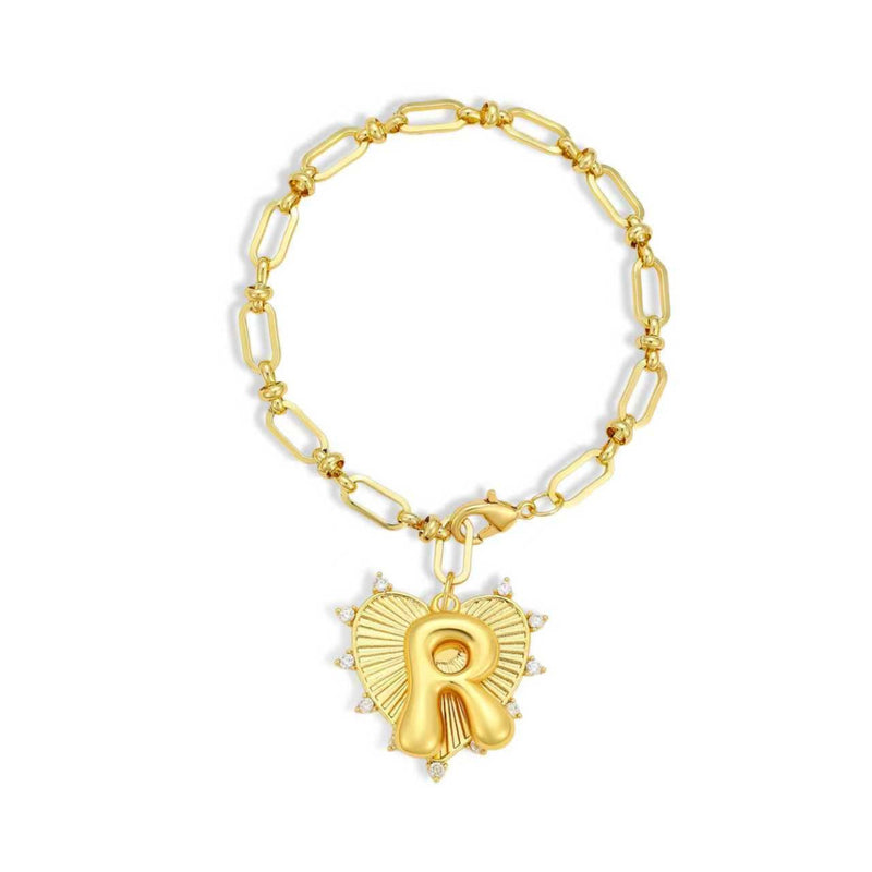 Gold chain bracelet with a heart-shaped charm and initial letter R over the heart charm on a white background