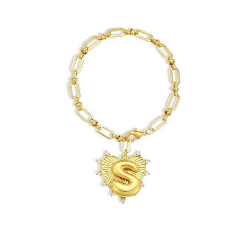 Gold chain bracelet with a heart-shaped charm and initial letter S over the heart charm on a white background