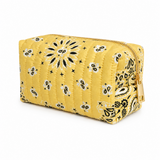 a bandana print quilted cosmetic case in yellow with gold tone zipper on white background