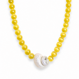 Necklace with yellow beads and a shell clasp on a white background