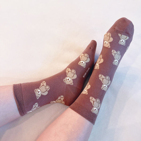 Cute and cozy set of three socks featuring playful bear designs in soft, neutral tones—perfect for adding a touch of whimsy to your everyday look.