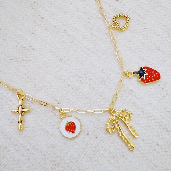 Gold charm bracelet with strawberry, heart, and bow – romantic playful bracelet