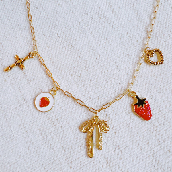 Gold charm bracelet with strawberry, heart and bow – romantic playful bracelet