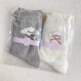 Set of two crew-length socks featuring charming embroidered Bichon Frise puppy design. Each pair showcases a soft color and is crafted from a stretchy & cozy material, perfect for everyday wear with a playful and cute flair.
