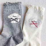 Set of two crew-length socks featuring charming embroidered Bichon Frise puppy design. Each pair showcases a soft color and is crafted from a stretchy & cozy material, perfect for everyday wear with a playful and cute flair.