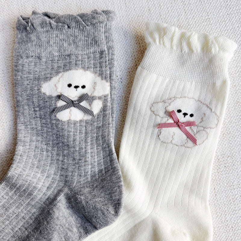 Set of two crew-length socks featuring charming embroidered Bichon Frise puppy design. Each pair showcases a soft color and is crafted from a stretchy & cozy material, perfect for everyday wear with a playful and cute flair.