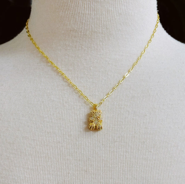 Sparkling gold-tone necklace featuring a playful bear-shaped pendant encrusted with shimmering rhinestones.