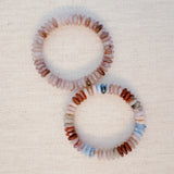 Stretch bracelet made of natural stone disc beads in soft blush, beige, and taupe tones arranged in a gradient pattern