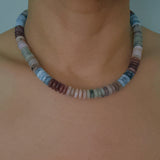 Beaded necklace made with natural stone disc beads in warm blush, beige, and soft brown tones arranged in a smooth, gradient pattern.