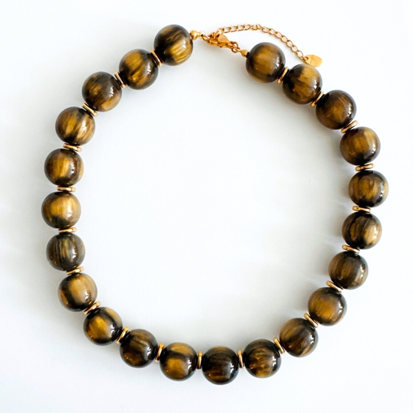 Chunky round bead necklace featuring high-shine polished sphere beads arranged in a single statement strand, showcasing a bold and modern look