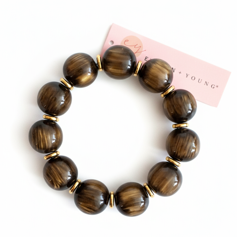 Bold stretch bracelet featuring large, polished round beads with a high-shine finish. The design showcases a uniform strand of smooth, spherical elements in a statement style.