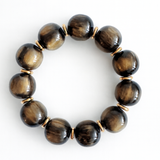 Bold stretch bracelet featuring large, polished round beads with a high-shine finish. The design showcases a uniform strand of smooth, spherical elements in a statement style.