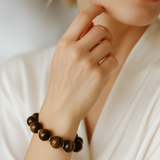 Bold stretch bracelet featuring large, polished round beads with a high-shine finish. The design showcases a uniform strand of smooth, spherical elements in a statement style.