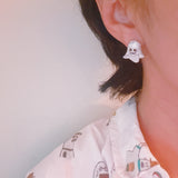 Sparkly ghost-shaped earrings with stone accents and playful expressions, combining spooky charm with glamorous bling for a festive Halloween accessory