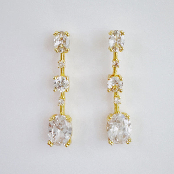 Elegant drop earrings featuring brilliant cubic zirconia stones in a sleek, cascading design, delivering radiant sparkle with every movement for a refined and timeless look.