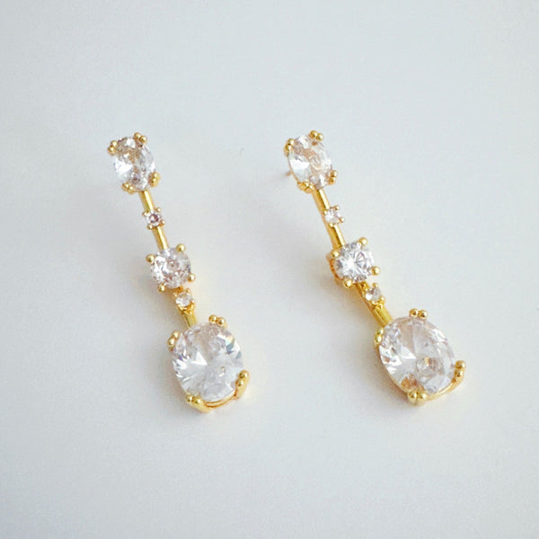 Elegant drop earrings featuring brilliant cubic zirconia stones in a sleek, cascading design, delivering radiant sparkle with every movement for a refined and timeless look.