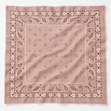 A square bandana in dusty rose pink with a classic paisley pattern in dark brown and cream, featuring fringed edges and a decorative border.
