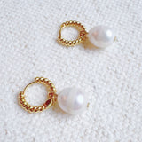 Gold cabled huggie hoop earrings with natural freshwater pearls – elegant and minimalist design