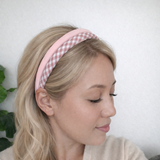 A set of padded fabric headbands in assorted pastel and plaid designs, including soft pink, green tones. Each headband features a cushioned, textured surface that blends solid and patterned fabrics for a stylish, comfortable everyday accessory.