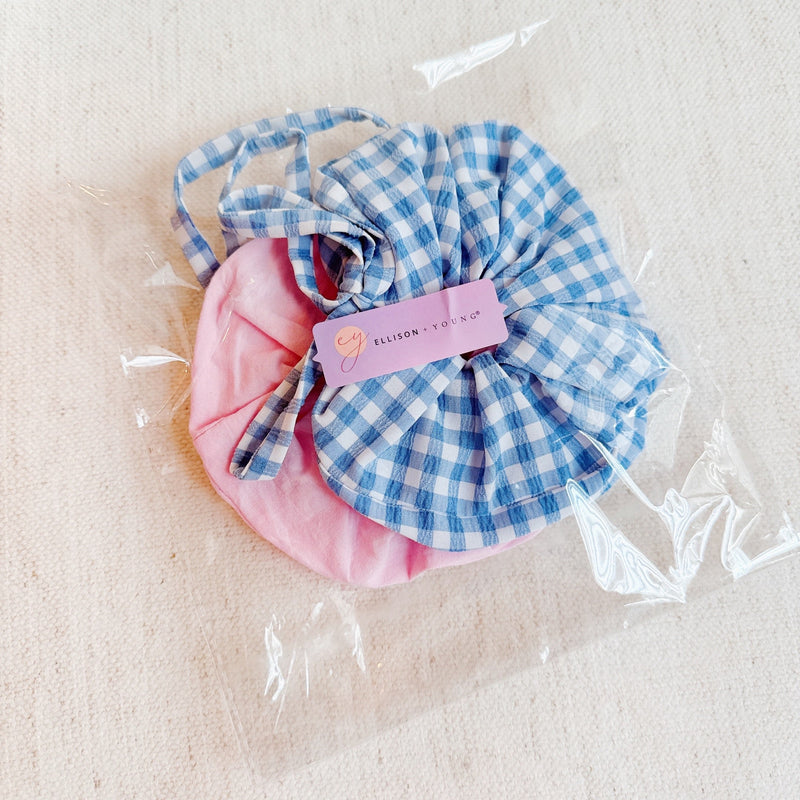 Set of two hair scrunchies featuring bold checkered patterns with elegant trailing ribbons—perfect for adding a playful yet polished touch to any hairstyle.