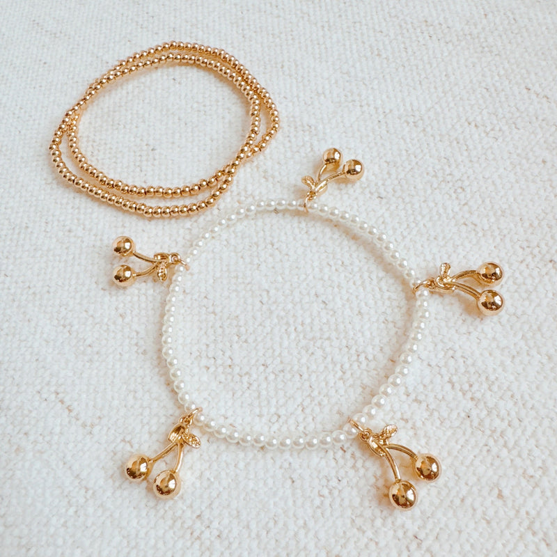  Set of three stretch bracelets adorned with dangling cherry charms—adding a sweet and playful flair to your accessory collection.