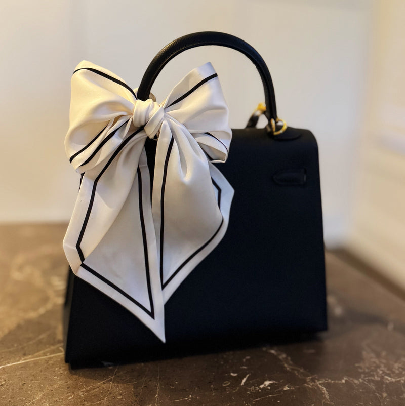 Elegant ribbon-style scarf with contrasting edges, perfect for adding a refined touch to hairstyles, handbag handles, or necklines.