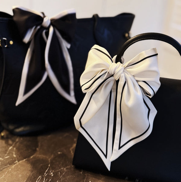 Elegant ribbon-style scarf with contrasting edges, perfect for adding a refined touch to hairstyles, handbag handles, or necklines.